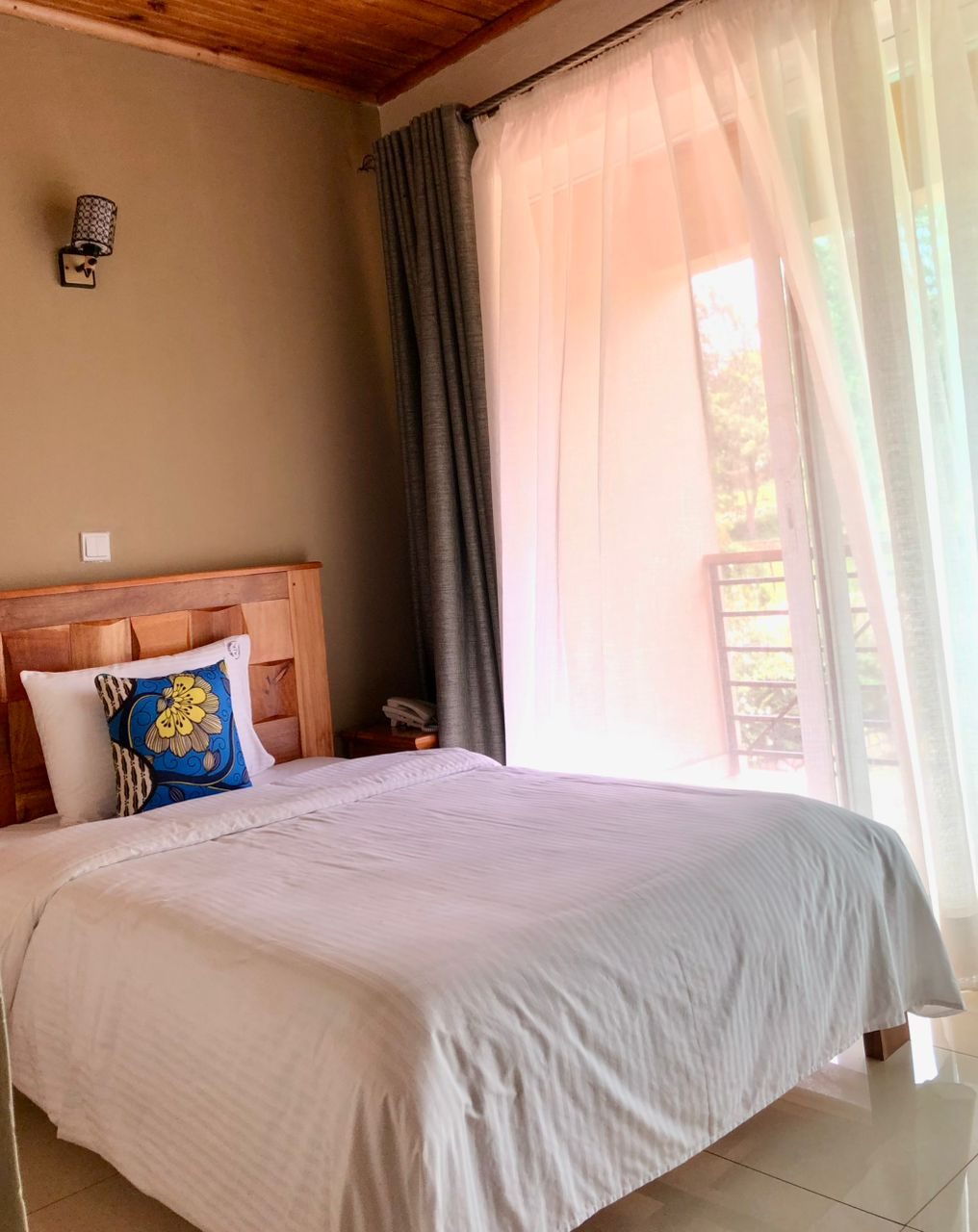 Single Room bed beside soft natural light